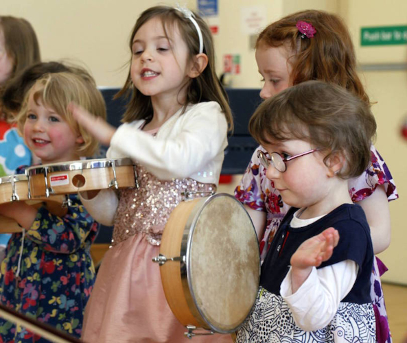 girl playing a tamborine